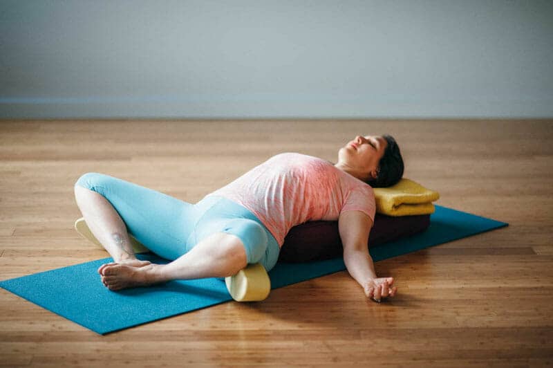Reclined Bound Angle Pose (Supta Baddha Konasana) - 9 Yoga Poses that Relieve Menstrual Cramps (With Variations)