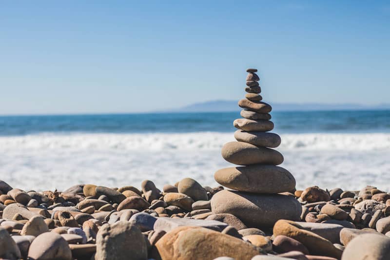 stacked rocks beach Holistic Wellness: 12 Ways to Start Your Journey